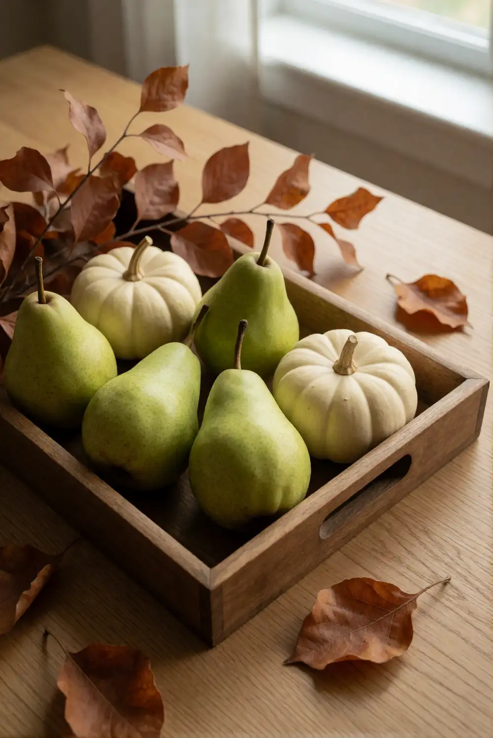 A Low Harvest Centerpiece with Pears and Foliage