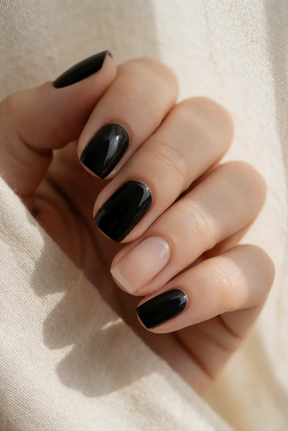 Glossy Black Nails with a Nude Accent