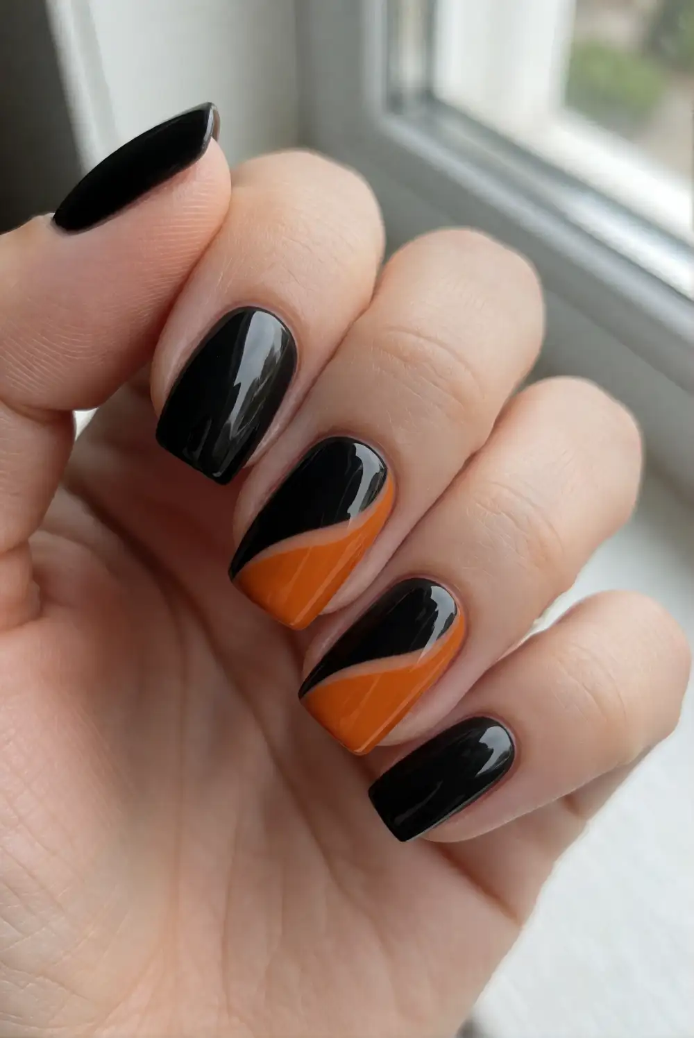 Glossy Black Nails With Orange Side Swoops