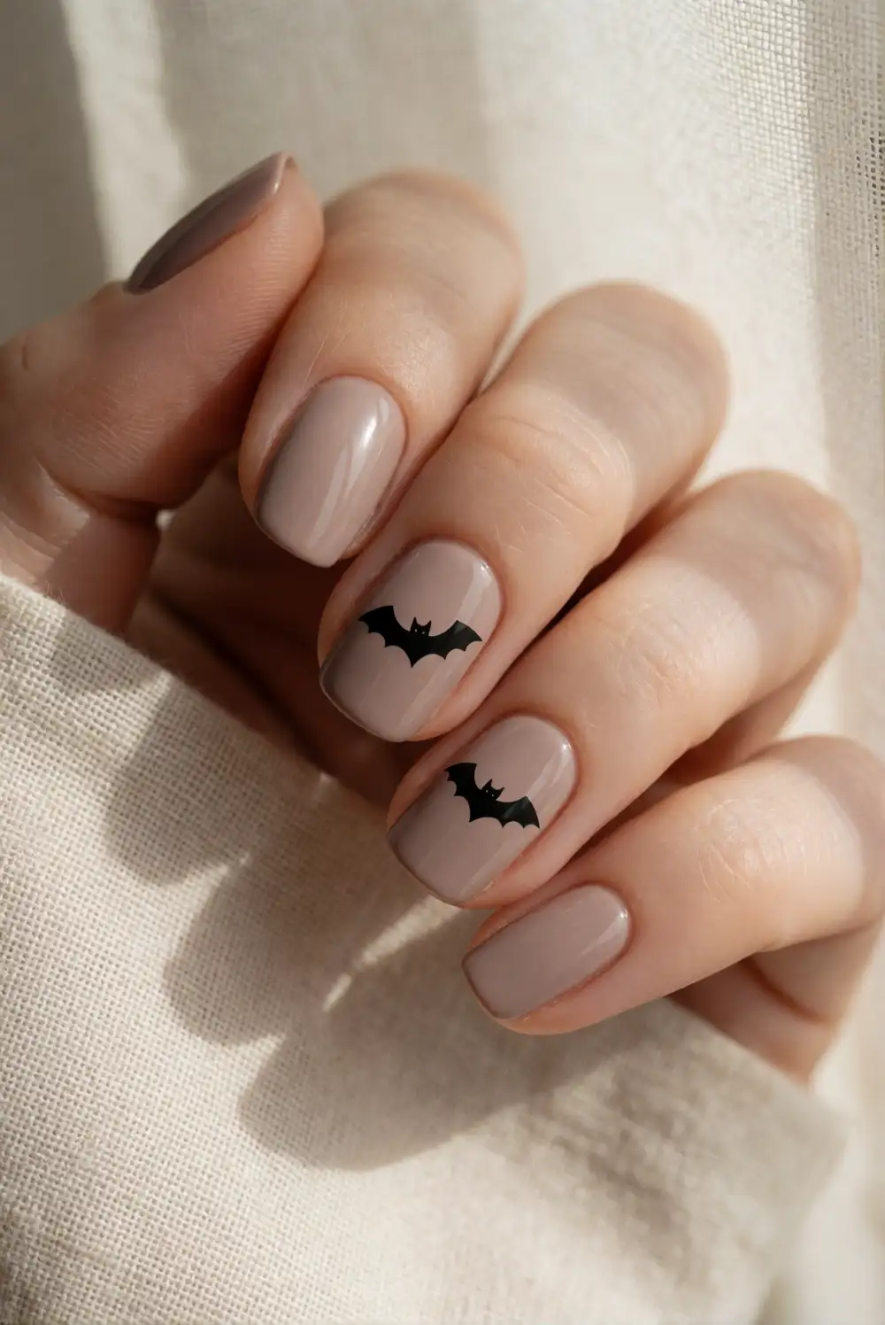 Soft Taupe Nails with Tiny Black Bats